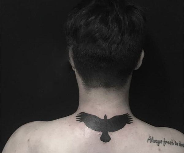 mini eagle tattoo on back of neck