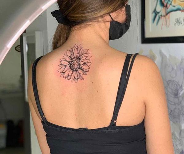 mini sunflower tattoo on back of neck