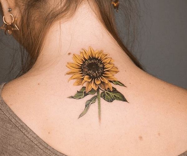 beautiful sunflower tattoo on the back of the neck