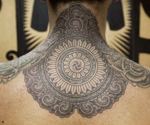 beautiful pattern tattoo on the back of the neck